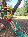 Net slide during a workshop on the treetop adventure course adapted for children aged 4 to 12. Family adventures based on a day trip idea from the Tourist Office