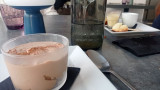 Homemade dessert during lunch at Accadémia Caffé, featuring a panoramic view of the Miroir aux Oiseaux and the Island district