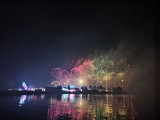 The fireworks display is multi-colored: pink, red, green, and yellow. This gives a joyful feel to the celebration, the Venetian Evening in Martigues.