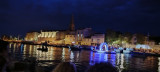 The illuminated floats parade along the Martigues Canal, passing alongside the buildings lit by their passage. The float in the foreground represents a gondola, like Venice.