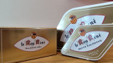 Presentation of the three boxes and cases of calissons d'Aix-en-Provence from Roy René with different sizes. In gold and white colors, the brand is clearly visible on these elegant calisson-shaped box
