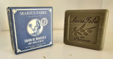 150g Marius Fabre green Marseille soap displayed front-facing next to its packaging, showcasing the soap's design and color