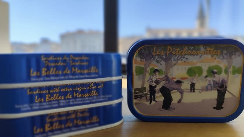 Can of small Ferrigno sardines with a Provençal design depicting pétanque players. The Les Belles de Marseille range is available for purchase at the Martigues Tourist Office.