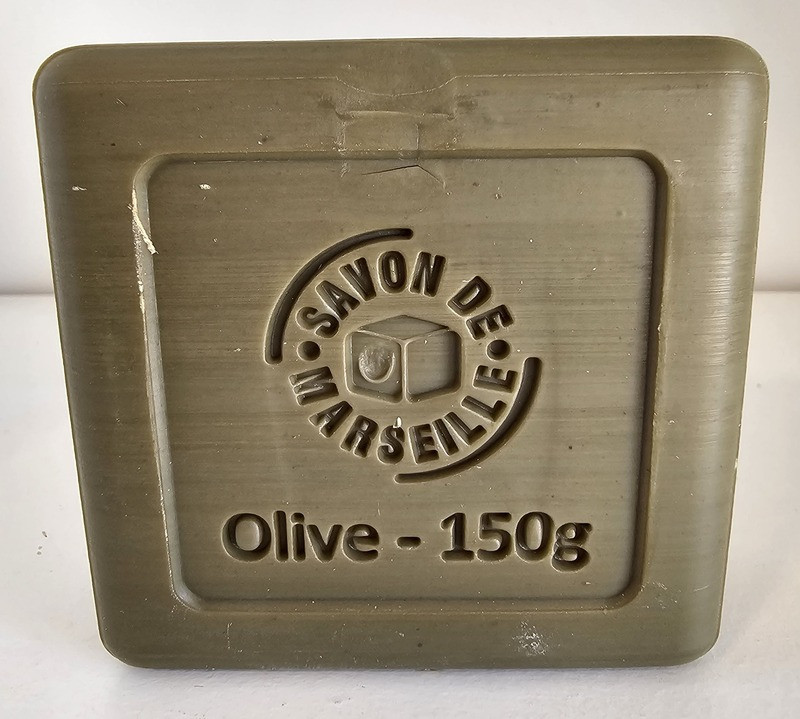 Marius Fabre - Green Marseille soap 150gr - © Otmartigues / SergeT 150g Marius Fabre green Marseille soap viewed from the back, featuring the inscription 'Olive 150g' and the 'Savon de Marseille' stamp