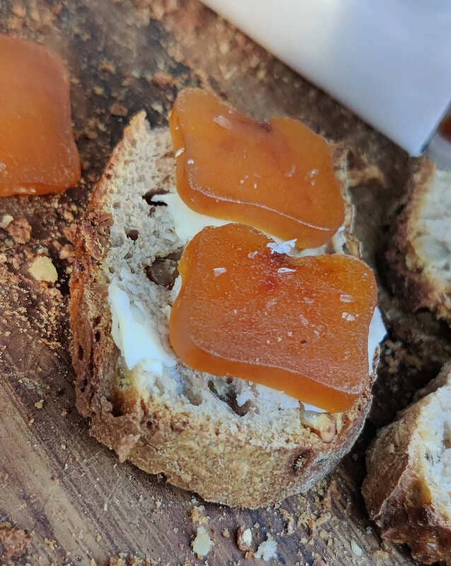 Pieces of bottarga placed on a thick slice of bread, buttered, all on a wooden table that accentuates the naturalness of the photo. - © Otmartigues / SergeT